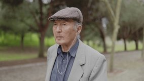 Elderly man listening music while walking in park - Powered by Shutterstock - Get 15% off with code: PIKWIZARD15