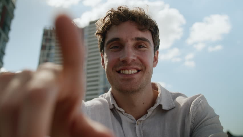 Caucasian man tapping scrolling internet social media networks browsing POV webcam guy smile virtual reality male touchscreen AR swipe smartphone mobile phone businessman business city outdoor display - Powered by Shutterstock - Get 15% off with code: PIKWIZARD15