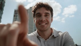 Caucasian man tapping scrolling internet social media networks browsing POV webcam guy smile virtual reality male touchscreen AR swipe smartphone mobile phone businessman business city outdoor display - Powered by Shutterstock - Get 15% off with code: PIKWIZARD15