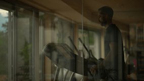A Man Engaged in Exercising on a Treadmill Within a Contemporary Gym Environment - Powered by Shutterstock - Get 15% off with code: PIKWIZARD15