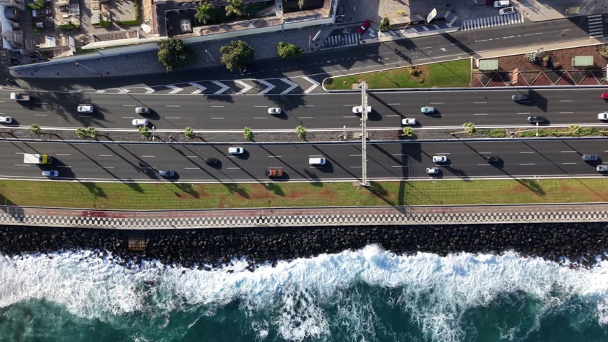Coastline view of Las Palmas de Gran Canaria with bustling roads and waves crashing