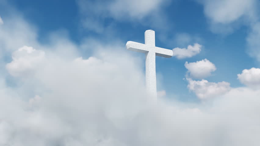 marble crucifix stands out among the white clouds in the blue sky