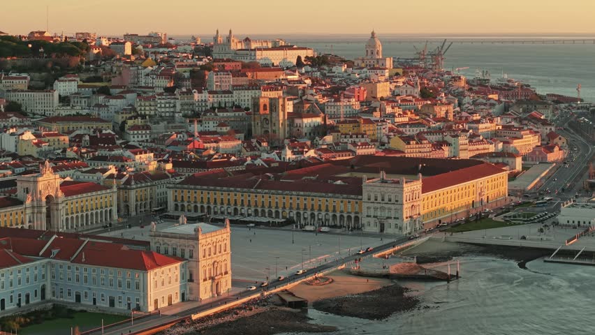 Morning aerial view of Lisbon showcasing vibrant cityscape and historic architecture during sunrise. Fly over Commerce Square, Palace Yard, Royal Palace of Ribeira in Lisbon, Portugal