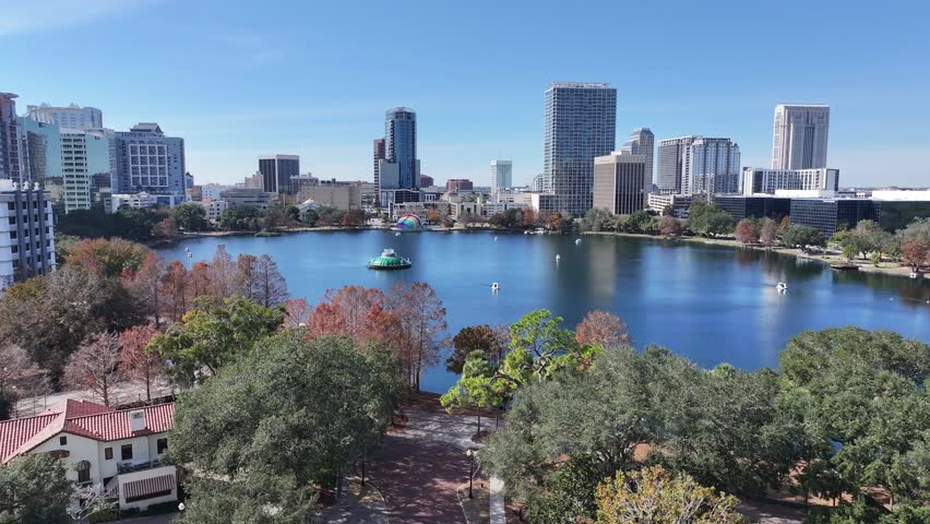 Orlando Skyline At Orlando Florida United States. Aerial View Of Green Space Surrounded By Lush Forest Trees. Business Sky Background Downtown Cityscape. Business Panning Wide. Orlando Florida.
