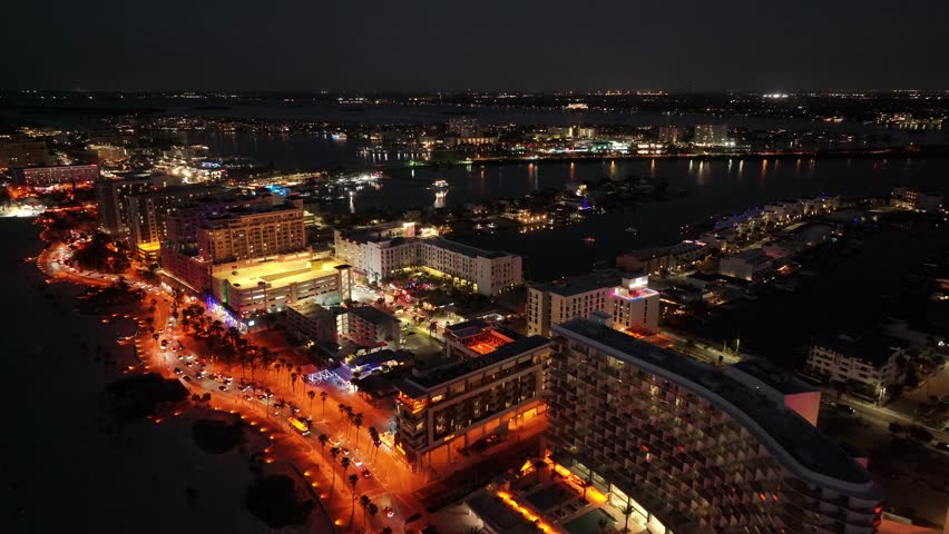 Clearwater Skyline At Clearwater Florida United States. Turquoise Ocean Waves Gently Crashing On Tropical Beach. Building Sky Background Downtown Cityscape. Night Outdoor Panoramic.