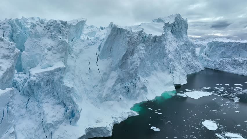Aerial view of huge iceberg in east Greenland. Exploring stunning glacial landscapes of Greenland showcasing icebergs and dramatic cliffs
