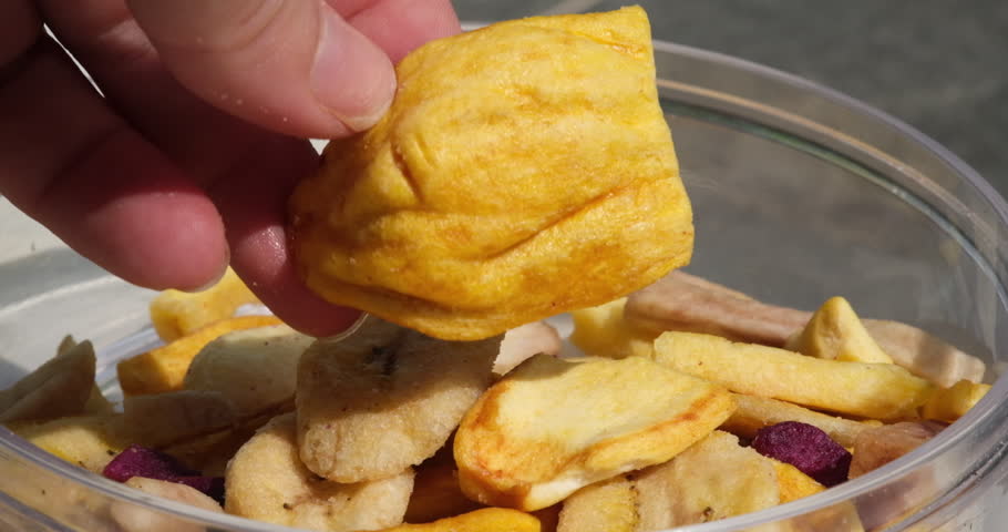 jackfruit dried fruitFemale hands peeling a jackfruit and remove the seeds to sell the jackfruit's meat. Thailand sweet fruit. Vertical video.