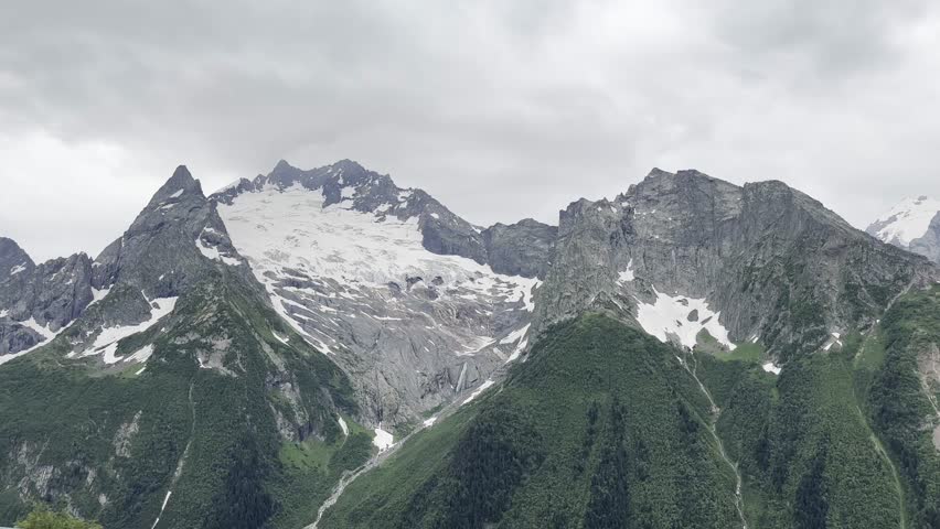 Majestic Mountain Landscape With Snow-Capped Peaks and Clouds. Generative AI