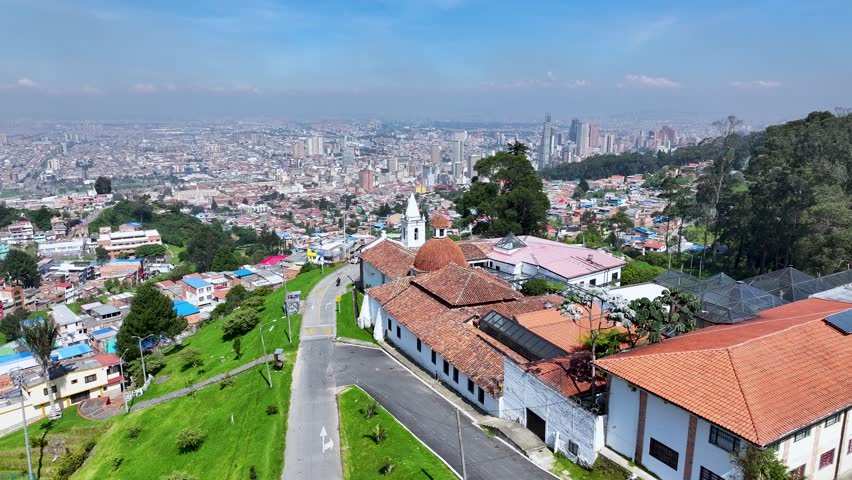 Bogota, District Capital, Colombia - 2.10.2025 - La Pena Church At Bogota In District Capital Colombia. Sunny Day. Aerial View Of A High-Rise Buildings And Traffic Showcasing Urban Life.