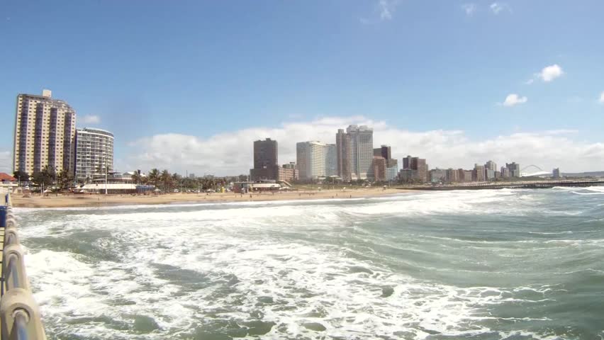Panorama photo of Durban beachfront or cityscape. View from the main pier towards the big city skyscrapers on a sunny day.