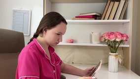 girl teen plays in a tablet online game. girl indoors child social media tablet internet slow motion video pink room pijamas flowers  - Powered by Shutterstock - Get 15% off with code: PIKWIZARD15