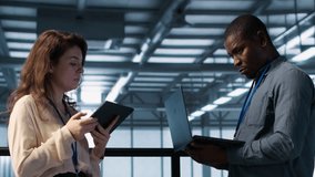 Colleagues in data center workplace use laptop to calibrate energy usage. Server farm IT specialist using notebook to inspect UPS configurations, doing maintenance on equipment, camera A - Powered by Shutterstock - Get 15% off with code: PIKWIZARD15