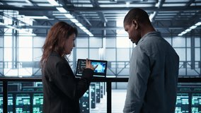 Software developers in data center use AI technology on tablet to optimize storage volumes. IT specialists in server hub facility using artificial intelligence to ensure seamless operations, camera B - Powered by Shutterstock - Get 15% off with code: PIKWIZARD15