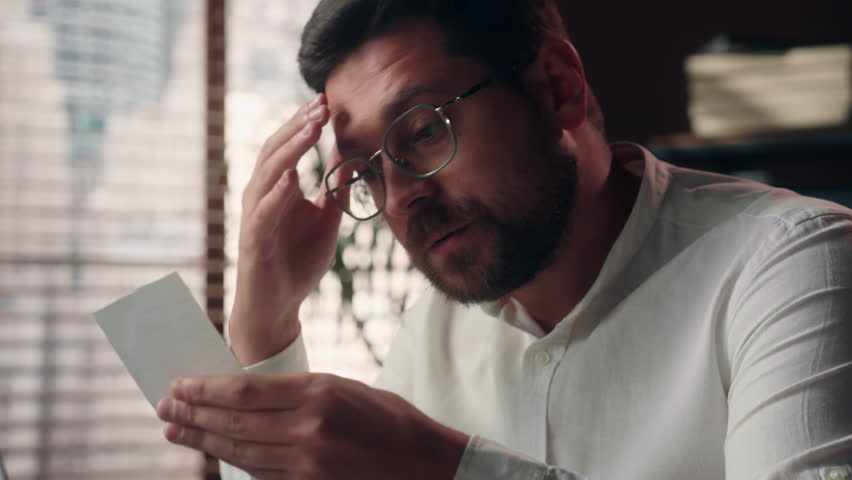 Busy pensive upset Caucasian male ceo boss worker reading bill in office businessman employer accountant count payroll bank guy executive entrepreneur work paying expenditure man business calculating