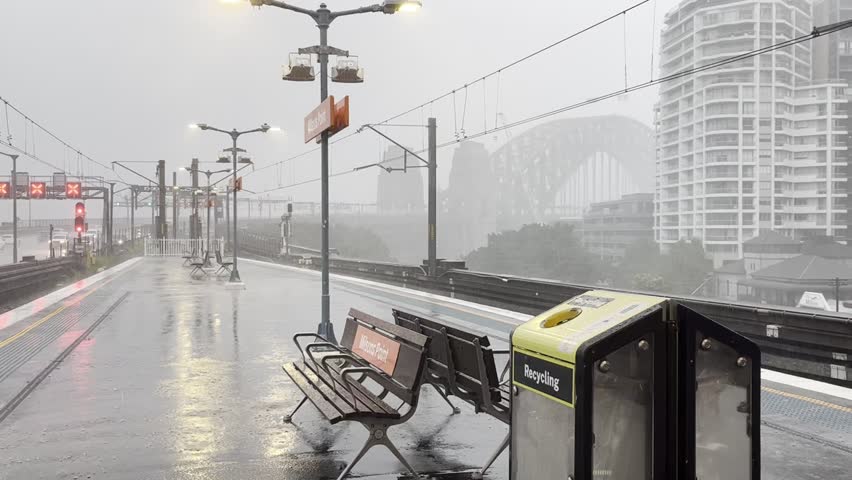 Milson’s Point Station on a rainy Monday at lunch time with view of the Sydney Harbour Bridge. 