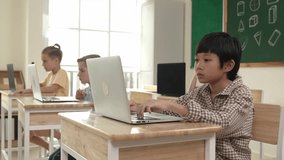 Asian boy working on his laptop while learning about coding engineering prompt at STEM technology class. Attractive smart students studying about programing software system to generate AI. Pedagogy. - Powered by Shutterstock - Get 15% off with code: PIKWIZARD15