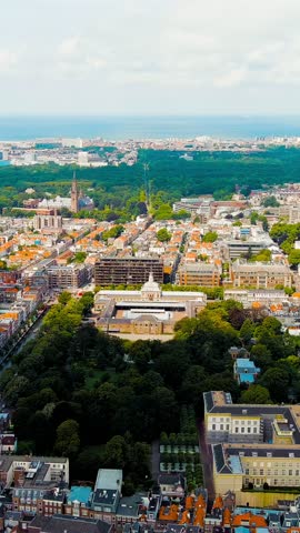 Vertical video. The Hague, Netherlands. Royal Stables. Paleistuin - park. Cloudy weather. Summer day, Aerial View, Point of interest. Rich colors