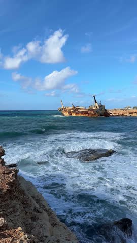 The old ship ran aground, shipwreck off the coast, abandoned ship, off the coast of Cyprus. Ecological disaster. 4 K Vertical