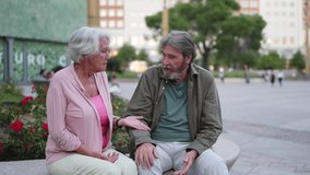 Elderly couple having a conversation on a bench in a public park, enjoying their retirement together - Powered by Shutterstock - Get 15% off with code: PIKWIZARD15
