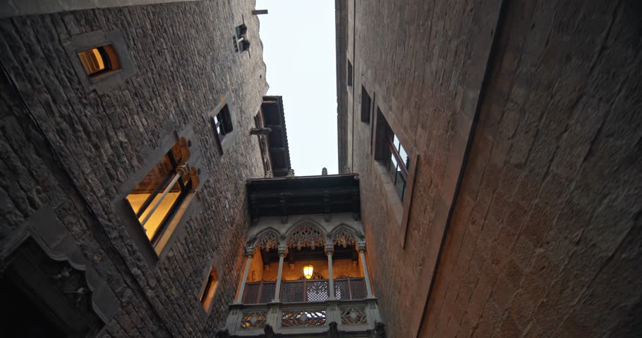 Magical night view of Barcelona Gothic Quarter Narrow stone streets, ancient buildings, and glowing lanterns highlight the beauty of Catalonia old town. High quality 4k footage