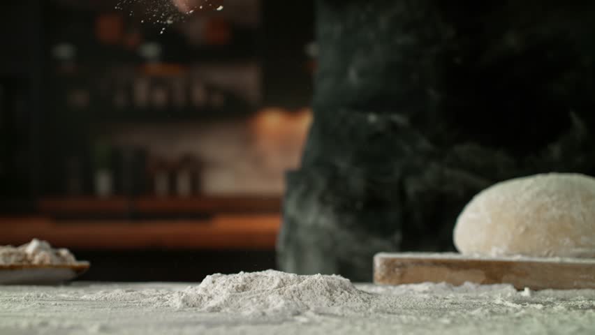 Super Slow Motion of Falling Yeast Dough into Flour . Filmed on High Speed Cinema Camera, 1000 fps . Closeup of Bread or Pizza Dough Preparation