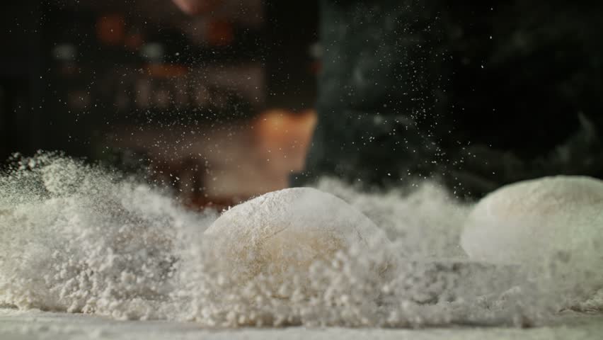 Super Slow Motion of Falling Yeast Dough into Flour . Filmed on High Speed Cinema Camera, 1000 fps . Closeup of Bread or Pizza Dough Preparation