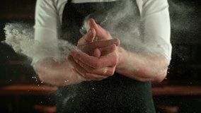 Super Slow Motion Chef Clapping Hands with Flour . Filmed on High Speed Cinema Camera, 1000 fps . Closeup of Bread or Pizza Dough Preparation - Powered by Shutterstock - Get 15% off with code: PIKWIZARD15