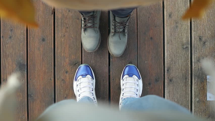 A man and woman walking on aged wooden floor, point of view perspective. High quality FullHD footage