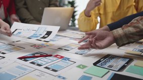 Collaborative Team Meeting for Website Design Concept with Prototypes and Digital Devices on a Table. SACTR - Powered by Shutterstock - Get 15% off with code: PIKWIZARD15