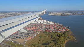 Aerial view of industrial port and cargo containers from airplane window, with clear blue sky. New York United States - Powered by Shutterstock - Get 15% off with code: PIKWIZARD15