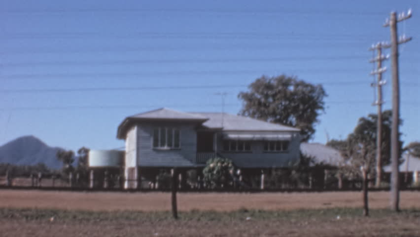 Rockhampton , Queensland , Australia - 05 10 1969: Tropic of Capricorn marker and house in Rockhampton, Australia. Medium static shot of roadside landmark. Useful for travel, geography, Australian his