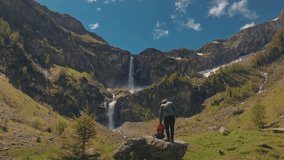 Aerial close up view of a tourist active man with a backpack hiking towards Lauenen waterfall Swiss Alps. Perfect for lifestyle, travel, vacation, and adventure in the Swiss Alps - Powered by Shutterstock - Get 15% off with code: PIKWIZARD15
