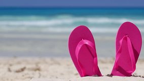 Pink flip flops on white sandy beach near caribbean sea, nobody. Summer vacations - Powered by Shutterstock - Get 15% off with code: PIKWIZARD15
