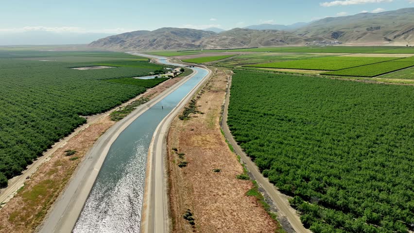Aerial of farms along an aqueduct running through California's Central Valley north of Los Angeles.