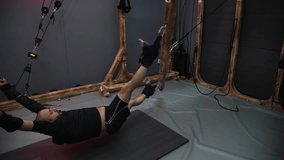 Patient performing rehabilitation exercises using innovative suspension equipment - Powered by Shutterstock - Get 15% off with code: PIKWIZARD15