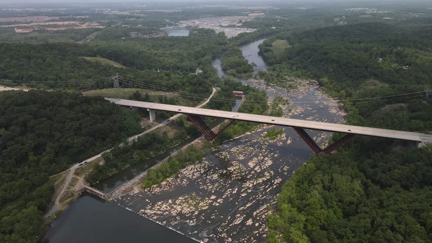 Bridge over the Shenandoah River. Dense green forest. View from above.
