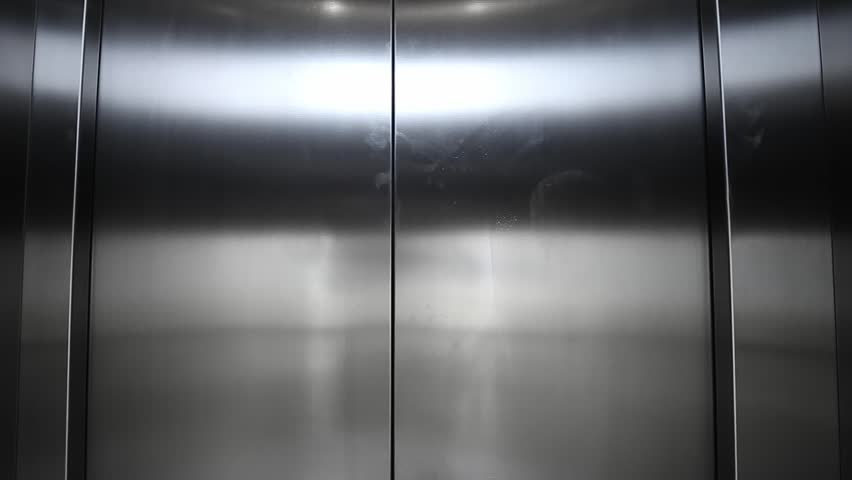 Elevator arrives and doors open, closeup