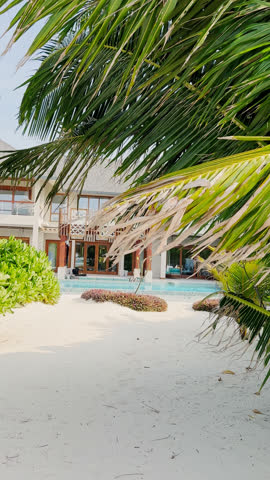 A private beach in the courtyard of a huge luxury villa with a private pool and water slide on a clear sunny day, a paradise for relaxation and vacation