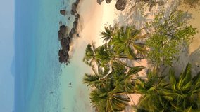 Vertical video. Aerial view of tropical beach landscape with white sand and turquoise sea on Koh Kham island in Thailand - Powered by Shutterstock - Get 15% off with code: PIKWIZARD15