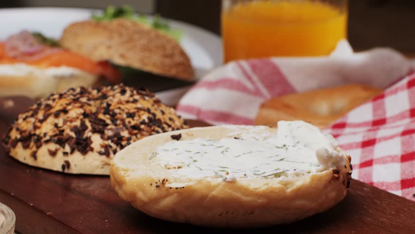 Bagel sandwich brunch, lunch plate of a bagel with smoked salmon and cream cheese and ham, close up morning cafe menu.