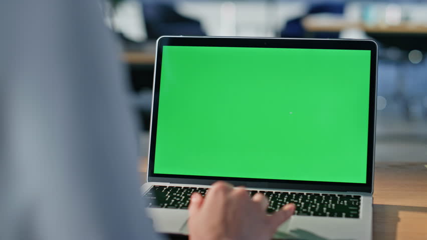 Startuper browsing mockup laptop at modern workplace closeup. Unrecognizable business woman reading email on green screen computer in office. Female hand using touchpad chroma key pc digital gadget.