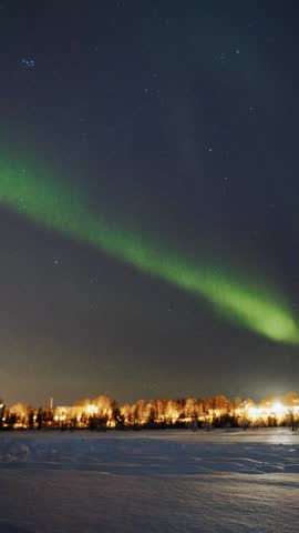 Aurora borealis vertical timelapse over Prestvannet lake in Tromso, Norway
