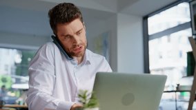 Overwhelmed office manager calling smartphone while typing laptop at workplace closeup. Busy corporate employee talking cellphone working at computer. Multitasking businessman solving business tasks. - Powered by Shutterstock - Get 15% off with code: PIKWIZARD15