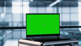 Green screen laptop in front of data center engineers in blurry background calibrating energy usage, inspecting servers configuration, supporting sustainable infrastructure, camera A - Powered by Shutterstock - Get 15% off with code: PIKWIZARD15