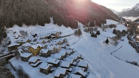 Aerial video above a small snowy village in winter in the Fontana val Bedretto Snow area, Switzerland - Powered by Shutterstock - Get 15% off with code: PIKWIZARD15
