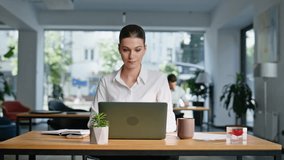 Confident lady starting workday sit down at desk office open space closeup. Elegant businesswoman holding coffee cup opening laptop at morning. Young female manager preparing for productive workflow. - Powered by Shutterstock - Get 15% off with code: PIKWIZARD15