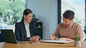 Confident businesswoman explaining project to man investor sitting office desk looking laptop closeup. Smiling professionals concluding agreement at corporate meeting. Man signing business contract. - Powered by Shutterstock - Get 15% off with code: PIKWIZARD15
