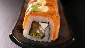 Sushi rolls with tuna and salmon with roe on black platter, closeup. Japanese cuisine - Powered by Shutterstock - Get 15% off with code: PIKWIZARD15