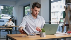 Professional manager sit down at modern workplace closeup. Focused company employee start work at contemporary coworking workspace. Serious businessman opening laptop at table in office open space. - Powered by Shutterstock - Get 15% off with code: PIKWIZARD15