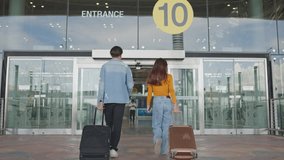Asian young couple passenger walk in airport terminal to boarding gate. Attractive man and woman friends tourist feel happy and excited for going travel abroad by airplane for holiday vacation trip. - Powered by Shutterstock - Get 15% off with code: PIKWIZARD15